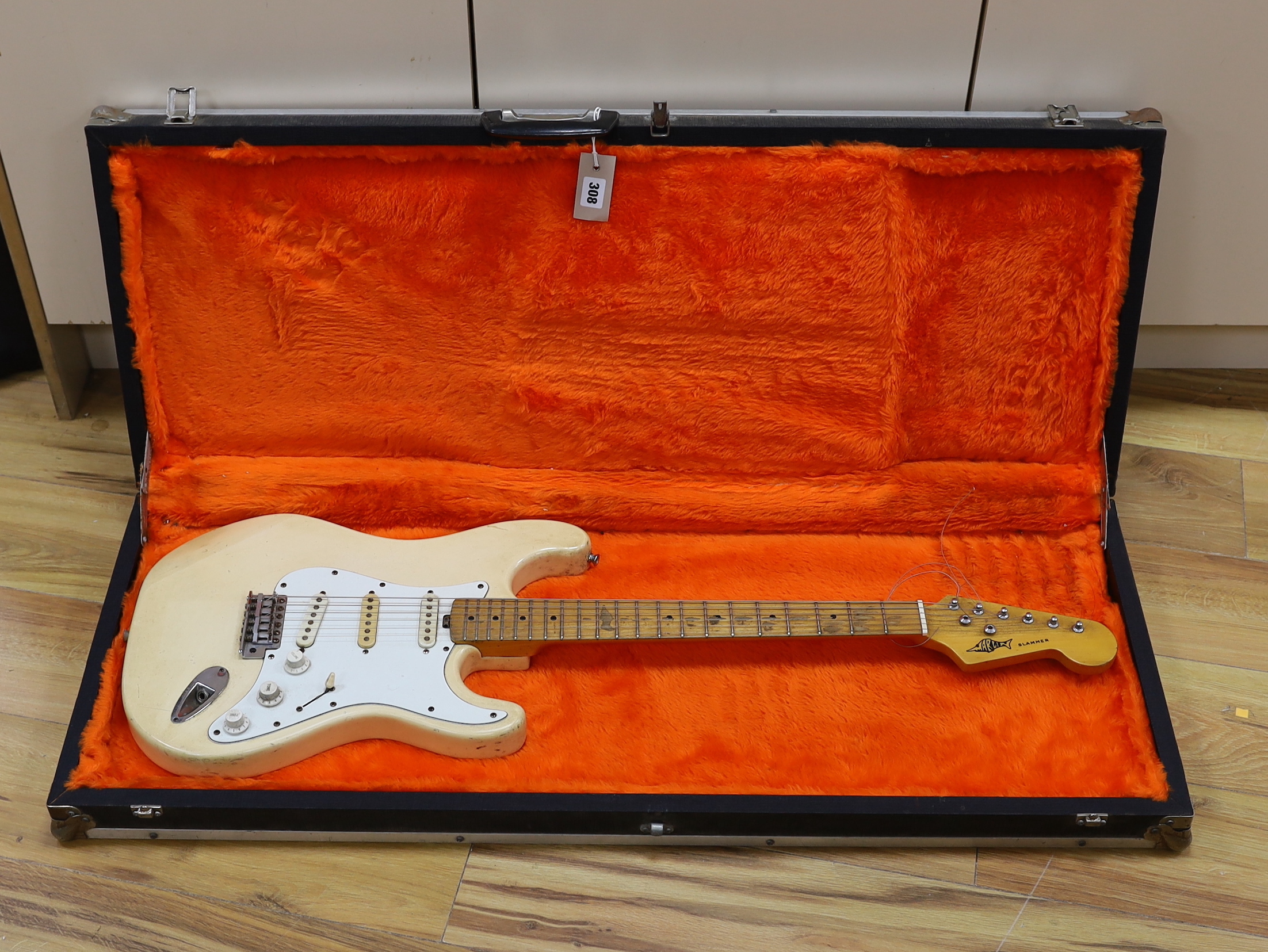 A Marlin Slammer electric guitar with maple neck, together with a flight case
